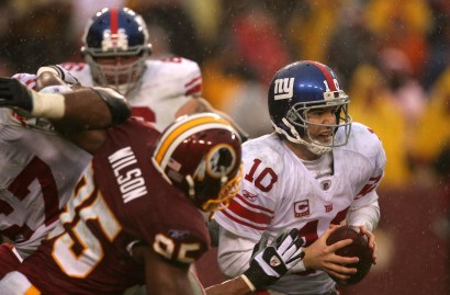 Eli Manning runs away from the Washington Redskins' defense.