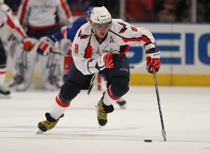 Ovechkin pushing a poker chip down the ice.