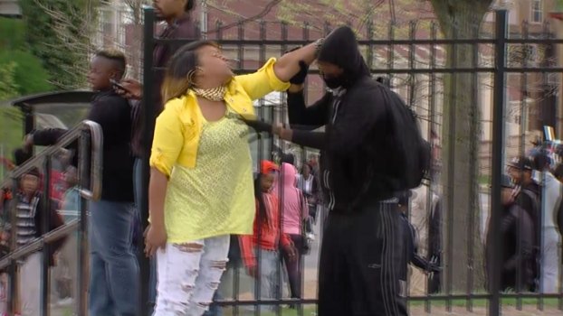 WATCH: Woman Pulls Boy From Baltimore Riot