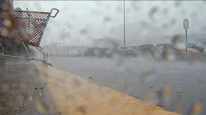 Shoppers caught in a downpour in Tysons Corner ran to get out of the rain but even an umbrella couldn't keep them dry in this storm.