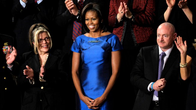 First Lady Michelle Obama wears a sapphire blue Barbara Tfank dress at the State of the Union. She also wore Tfank during a visit to Buckingham Palace last Spring.