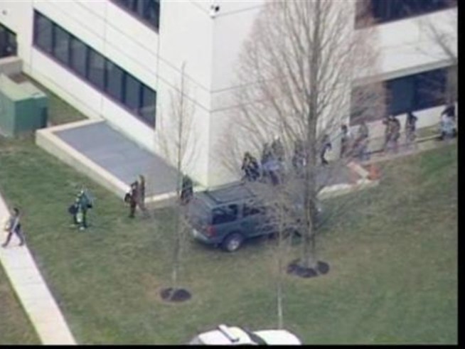 Students are escorted out of NOVA-Woodbridge campus buildings following a report of shots fired.
