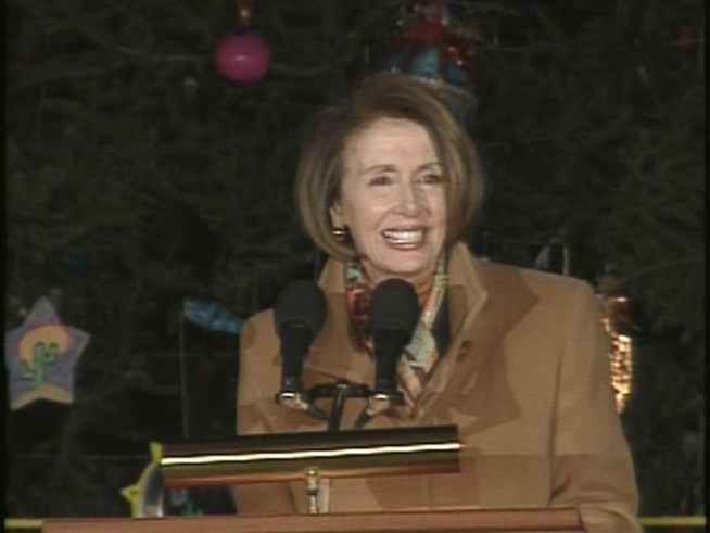 A seventh-grade student from Arizona helps Speaker of the House Nancy Pelosi light the Capitol Christmas Tree.