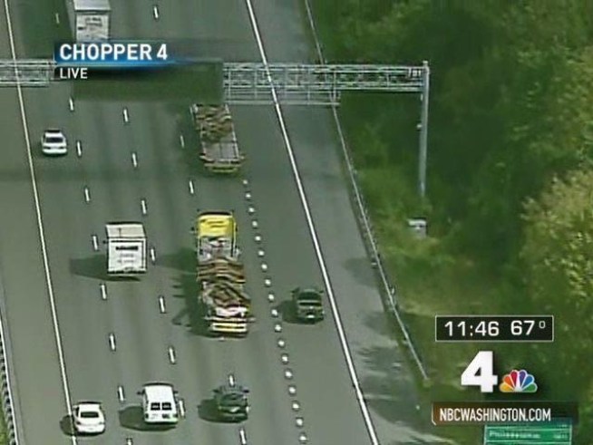 Police escort trucks hauling steel from the <a title=