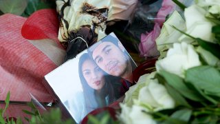 In this file photo, a picture of Bryce Fredriksz, right, and his girlfriend Daisy Oehlers, left, who died on flight MH17, is surrounded by flowers at Schiphol airport in Amsterdam, Sunday, July 20, 2014.