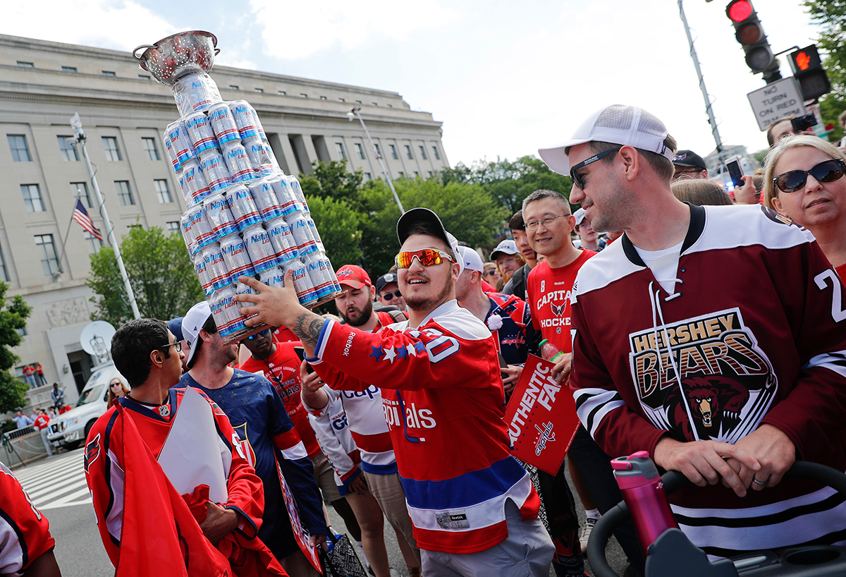 Washington Capitals' T.J. Oshie chugs a beer through his jersey at Stanley  Cup rally 