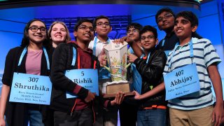 The eight co-champions of the 2019 Scripps National Spelling Bee, from left, Shruthika Padhy, 13, of Cherry Hill, N.J., Erin Howard, 14, of Huntsville, Ala., Rishik Gandhasri, 13, of San Jose, Calif., Christopher Serrao, 13, of Whitehouse Station, N.J., Saketh Sundar, 13, of Clarksville, Md., Sohum Sukhatankar, 13, of Dallas, Texas, Rohan Raja, 13, of Irving, Texas, and Abhijay Kodali, 12, of Flower Mound, Texas, hold the trophy at the end of the competition in Oxon Hill, Md., Friday, May 31, 2019.