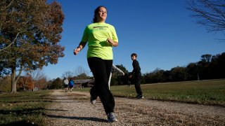 Grace Brown, 14, poses for a portrait while jogging at the park where she does her jogging workouts for her “online PE” class, in Alexandria, Va., Friday, Nov. 1, 2019. Brown chose to take “online PE,” utilizing a fitness tracker, so that she could take a piano lab as an extra elective. (AP Photo/Jacquelyn Martin)
