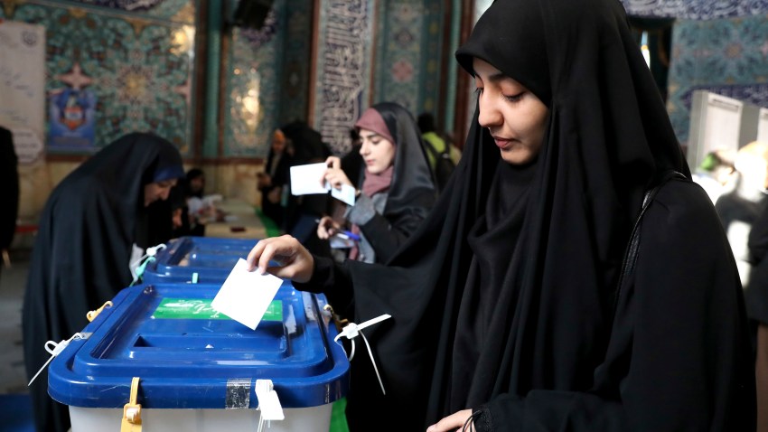 A woman votes in the Iranian election.