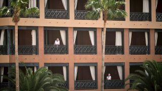 People stand at their balconies at the H10 Costa Adeje Palace hotel in Tenerife, Canary Island, Spain,