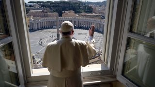 Pope Francis delivers his blessing from inside the Apostolic library at the Vatican