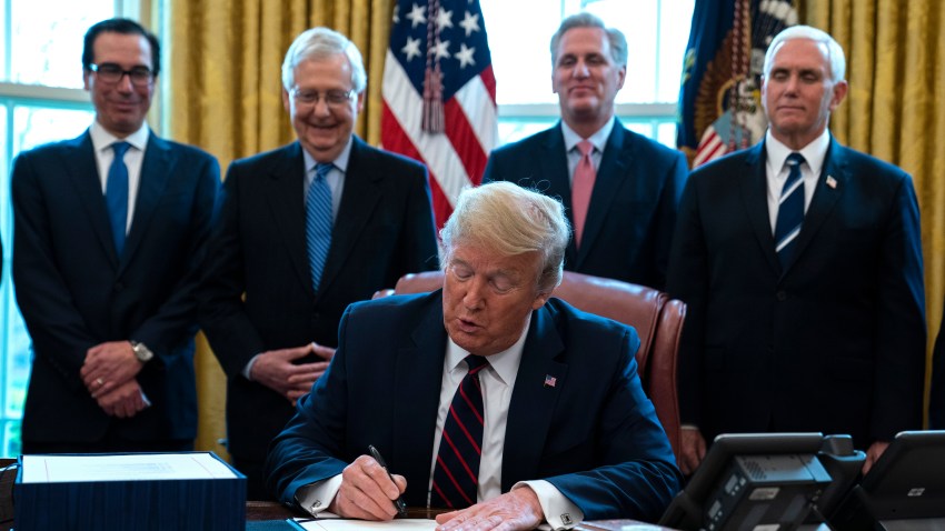 In this March 27, 2020 file photo, President Donald Trump signs the coronavirus stimulus relief package in the Oval Office at the White House in Washington, as Treasury Secretary Steven Mnuchin, Senate Majority Leader Mitch McConnell, R-Ky., House Minority Leader Kevin McCarty, R-Calif., and Vice President Mike Pence watch. Payments from a federal coronavirus relief package could take several weeks to arrive. While you wait, prep your finances and make a plan for using any money you receive.