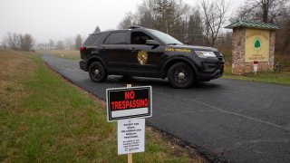 A Maryland State Trooper guards the driveway to the Pleasant View Nursing Home, in Mount Airy, Md., Sunday, March 29, 2020, by a sign that says “no trespassing” that was put up by the Carroll County Health Department. Maryland’s governor said Saturday night that the nursing home had been struck by an outbreak of COVID-19. (AP Photo/Jacquelyn Martin)