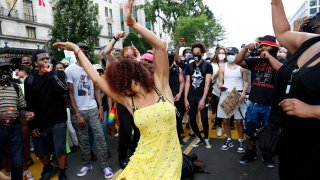Demonstrators dance as they protest