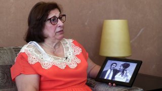 Laure Ghosn, whose husband Charbel Zogheib has been missing for the past 37 years, speaks as she holds their wedding portrait