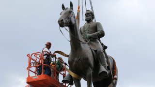 Work crews remove the statue of confederate general Stonewall Jackson, Wednesday, July 1, 2020, in Richmond, Va. Richmond Mayor Levar Stoney has ordered the immediate removal of all Confederate statues in the city, saying he was using his emergency powers to speed up the healing process for the former capital of the Confederacy amid weeks of protests over police brutality and racial injustice.