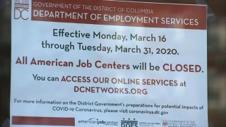 A sign instructs unemployment applicants in D.C. to file online.