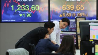 In this April 27, 2020, file photo, currency traders watch monitors at the foreign exchange dealing room of the KEB Hana Bank headquarters in Seoul, South Korea.