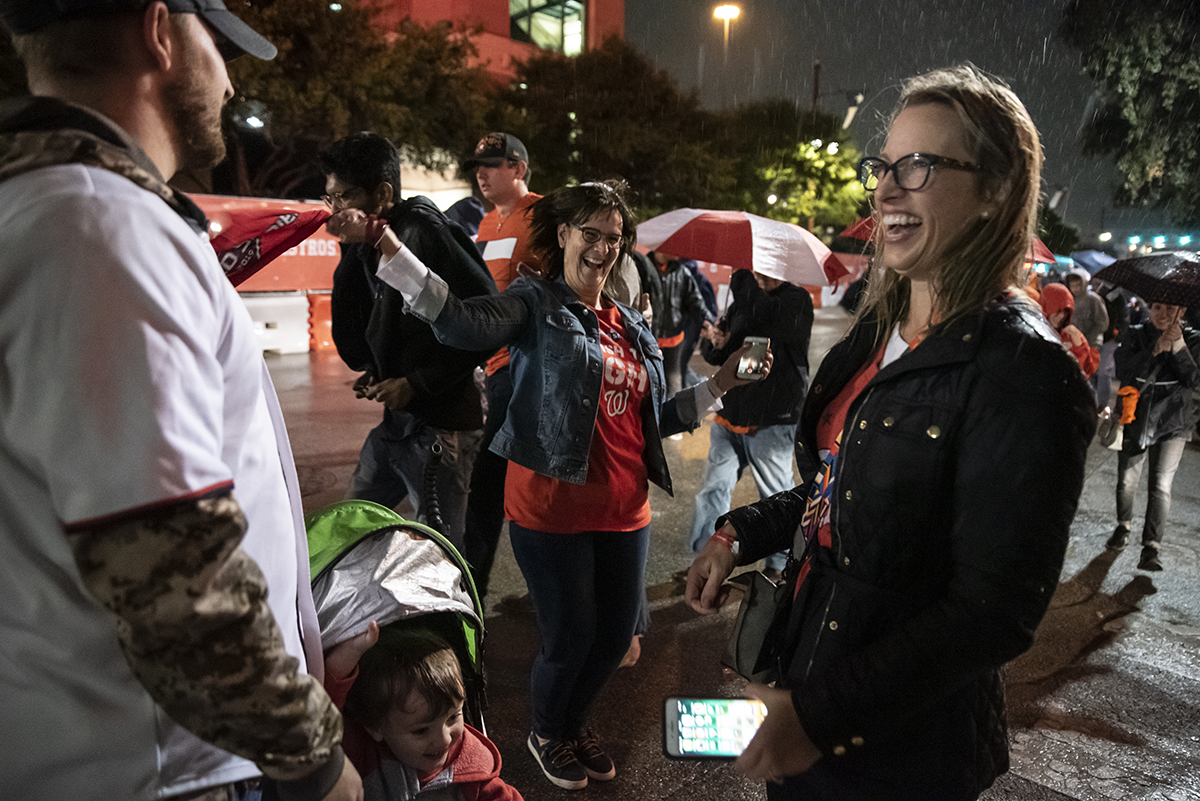 A small group of Washington Nationals fans celebrate their first World Series win on October 30, 2019 in Houston, Texas. After a three-run inning in the 7th, the Washington Nationals took the lead and would go on to win game 7 and their first-ever franchise World Series. (Photo by Sergio Flores/Getty Images)