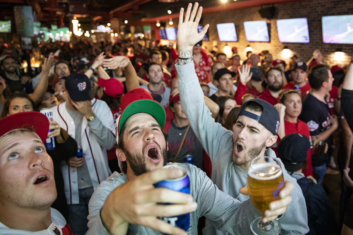 Fans react to the World Series Game 7 on a big screen just a block from Nationals Park at Walter's Sports Bar on October 30, 2019 in Washington, D.C. (Photo by Samuel Corum/Getty Images)