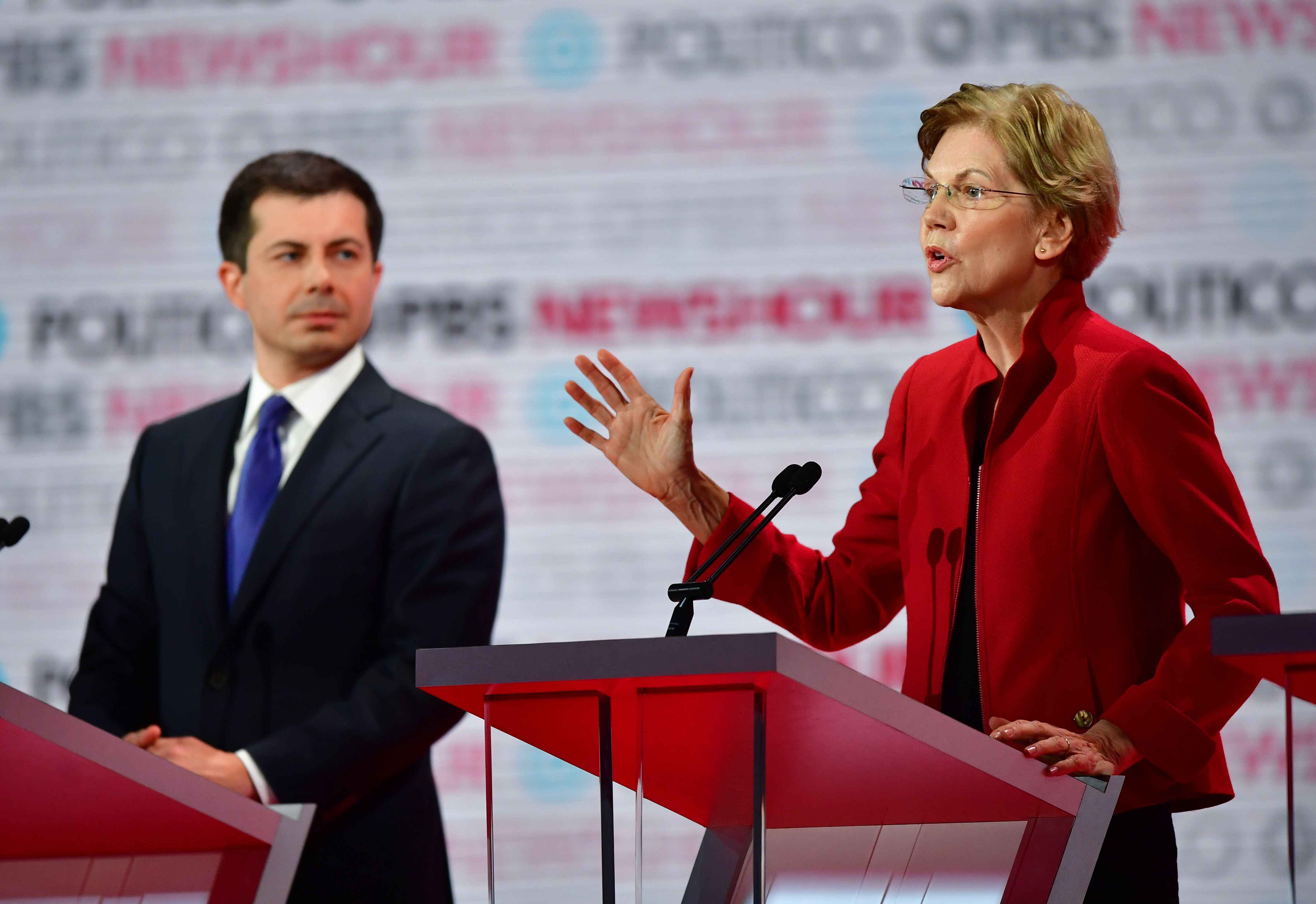 Democratic presidential hopeful Mayor of South Bend, Indiana, Pete Buttigieg listens to Massachusetts Senator Elizabeth Warren speak on stage during the sixth Democratic primary debate at Loyola Marymount University in Los Angeles, California on Dec. 19, 2019.