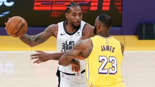 LeBron James of the Los Angeles Lakers guards Kawhi Leonard of the Los Angeles Clippers on Dec. 25, 2019, at STAPLES Center in Los Angeles.