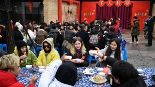 overseas students attend a long-table feast marking the upcoming Chinese Lunar New Year