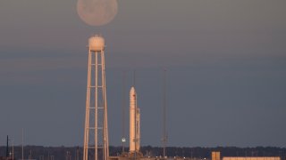 WALLOPS ISLAND, VA – FEBRUARY 9: In this NASA handout, A Northrop Grumman Antares rocket carrying a Cygnus resupply spacecraft is seen at sunrise as the Moon sets on Pad-0A, Sunday, Feb. 9, 2020, at NASA’s Wallops Flight Facility in Virginia. Northrop Grummans 13th contracted cargo resupply mission with NASA to the International Space Station will deliver about 7,500 pounds of science and research, crew supplies and vehicle hardware to the orbital laboratory and its crew. The CRS-13 Cygnus spacecraft is named after the first African American astronaut, Major Robert Henry Lawrence Jr., and is scheduled to launch at 5:39pm EST. (Photo by Aubrey Gemignani/NASA via Getty Images)