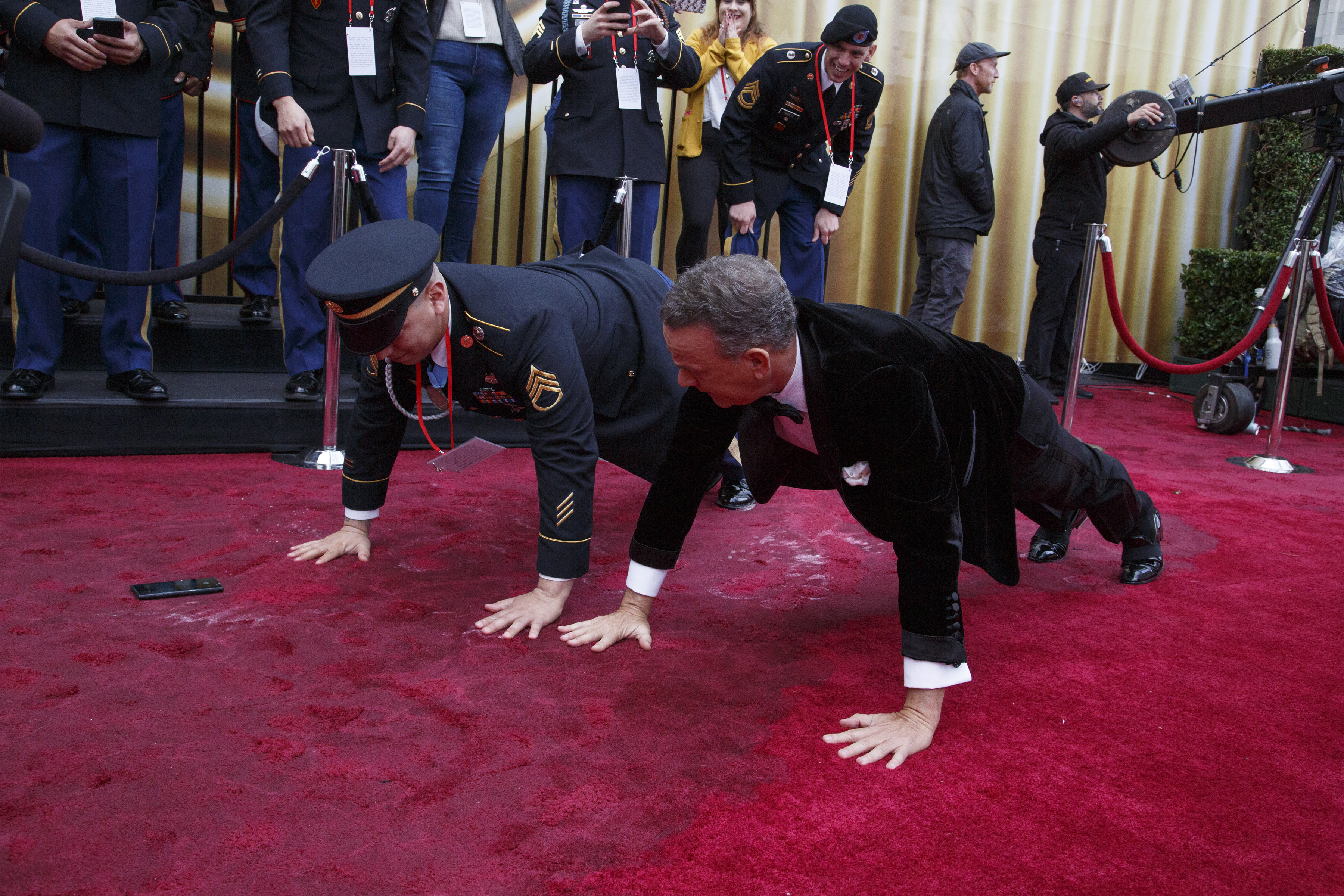 Tom Hanks, right, turned heads when he dropped on the red carpet at the Academy Awards and did a few push-ups alongside an army sergeant on Feb. 9, 2020, at the Dolby Theater in Los Angeles.