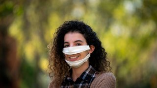 French leather creator Anissa Mekrabech, 30 year-old, wearing the protective face mask she created for the deaf and the hearing-impaired