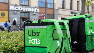 Uber Eats delivery bags wait in front of a McDonald's in Lublin, Poland on May 3, 2020.