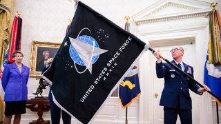 In this May 15, 2020, file photo, Chief Master Sgt. Roger Towberman (R), Space Force and Command Senior Enlisted Leader and CMSgt Roger Towberman (L), with Secretary of the Air Force Barbara Barrett present President Donald Trump with the official flag of the United States Space Force in the Oval Office of the White House in Washington, DC.