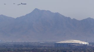 Luke AFB's 56th Fighter Wing and the 944th Fighter Wing and Arizona National Guard's 161st Air Refueling Wing fly over State Farm Stadium on May 1, 2020 in Glendale, Arizona.