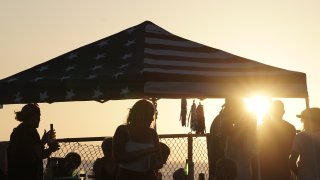 People gather under a canopy at sunset in Encinitas, Californi