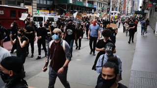 Following a night of some protests turned violent, demonstrations continue in Manhattan against the police killing of George Floyd on June 2, 2020 in New York City.