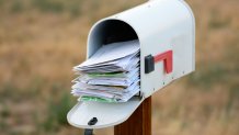 A mailbox overflows with mail in this file photo.