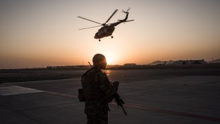 U.S. soldier watches a helicopter in Afghanistan
