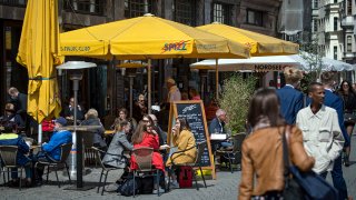 The outdoor seating area of a restaurant on the market square in Leipzig, Germany, sees customers reemerging as coronavirus lockdowns are scaled back.