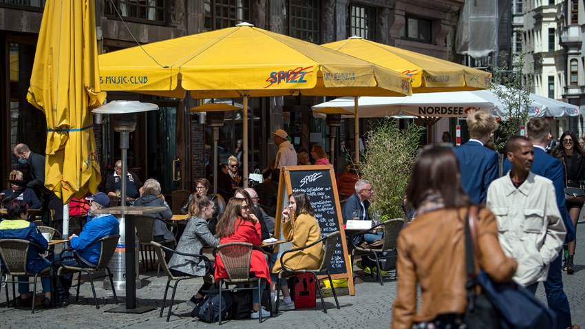 The outdoor seating area of a restaurant on the market square in Leipzig, Germany, sees customers reemerging as coronavirus lockdowns are scaled back.