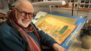 In this file photo taken Sunday Dec. 1, 2013, Tomie DePaola poses with his artwork in his studio in New London, N.H.