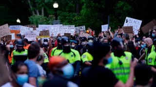 Protesters and police officers are seen at a peaceful demonstration in protest of the death of George Floyd and other black lives lost to police across the U.S. at Franklin Park in Boston, Massachusetts, June 2, 2020.