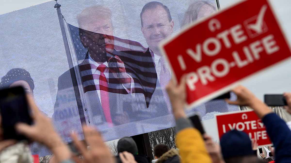 Pro-life demonstrators listen to US President Donald Trump as he speaks at the 47th annual “March for Life” in Washington, DC, on January 24, 2020. – Trump is the first US president to address in person the country’s biggest annual gathering of anti-abortion campaigners. (Photo by OLIVIER DOULIERY / AFP) (Photo by OLIVIER DOULIERY/AFP via Getty Images)