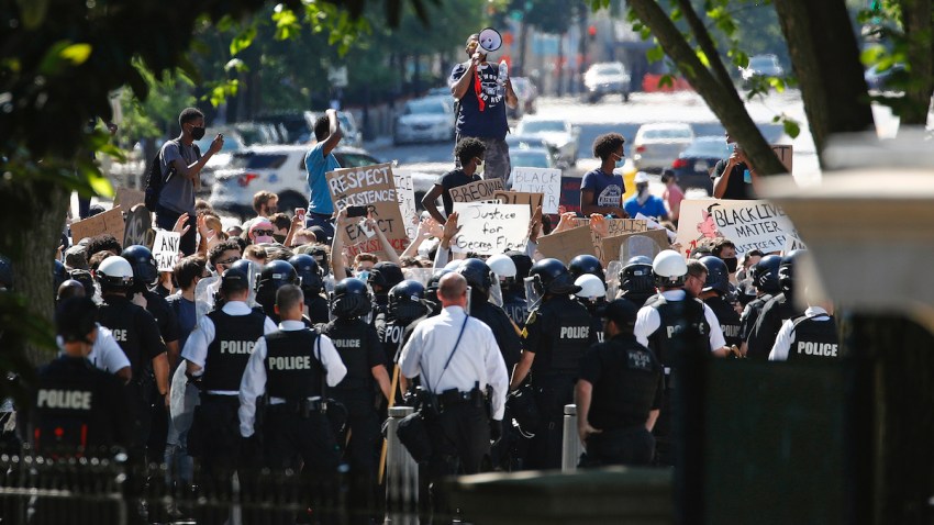 Protesters gather in front of a line of Uniformed U.S. Secret Service as demonstrators gather to protest the death of George Floyd, near the White House, Saturday, May 30, 2020, in Washington. Floyd died after being restrained by Minneapolis police officers.