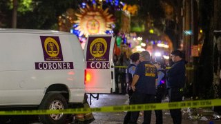 Emergency personnel work the scene after a person was run over and killed by a float in the Mystic Krewe of Nyx parade during Mardi Gras celebrations in New Orleans, Wednesday, Feb. 19, 2020.