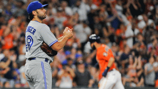 Toronto Blue Jays relief pitcher Mike Bolsinger, left, walks off the mound as Houston Astros' Marwin Gonzalez, right, rounds the bases after hitting a three-run home run during the fourth inning of a baseball game, Friday, Aug. 4, 2017, in Houston.