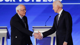 In this file photo, Democratic presidential candidates Sen. Bernie Sanders, I-Vt., left, and former Vice President Joe Biden, shake hands on stage Friday, Feb. 7, 2020, before the start of a Democratic presidential primary debate hosted by ABC News, Apple News, and WMUR-TV at Saint Anselm College in Manchester, N.H.