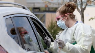 A nurse administers coronavirus testing at a drive-up facility at MedStar St. Mary's Hospital April 14, 2020, in Leonardtown, Maryland.