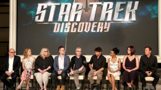 In this Aug. 1, 2017, file photo, (L-R) executive producers Akiva Goldsman, Heather Kadin, Gretchen Berg, Aaron Harberts, and Alex Kurtzman, and actors James Frain, Sonequa Martin, Mary Chieffo, and Jason Isaacs of "Star Trek: Discovery" speak onstage during the CBS portion of the 2017 Summer Television Critics Association Press Tour at CBS Studio Center in Los Angeles, California.