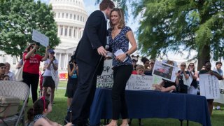 Maeve Kennedy McKean greets Rep. Joe Kennedy, D-Mass., during a rally on the East Front lawn of the Capitol to condemn the separation and detention of families at the border of the U.S. and Mexico on June 21, 2018. (Photo By Tom Williams/CQ Roll Call)