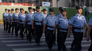 Chinese policemen prepare for duty around a neighborhood sealed off before the official closure of the United States Consulate in Chengdu in southwest China's Sichuan province, Monday, July 27, 2020.